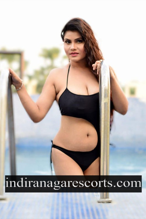 Jyothika, Indiranagar escort, in a black bikini beside the pool steps