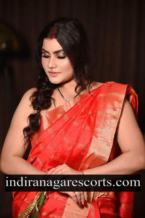 Jyothika, Indiranagar call girl service, in a red silk saree with a gold border