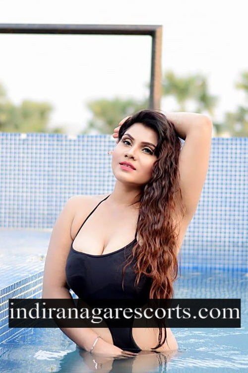 Jyothika, Indiranagar escort, standing in the pool in a black swimsuit
